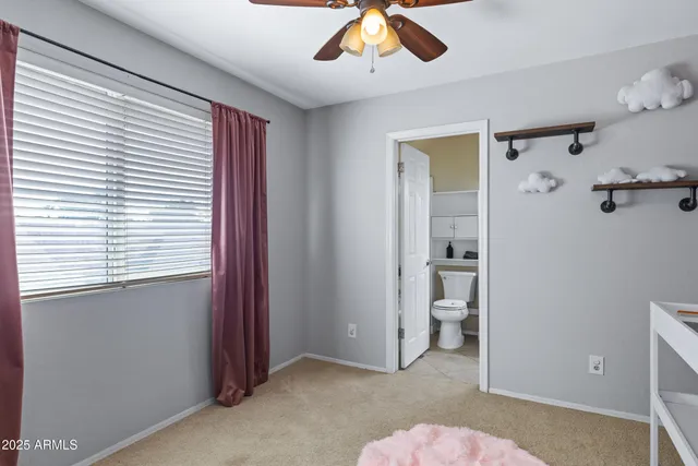 a bedroom with window and ceiling fan