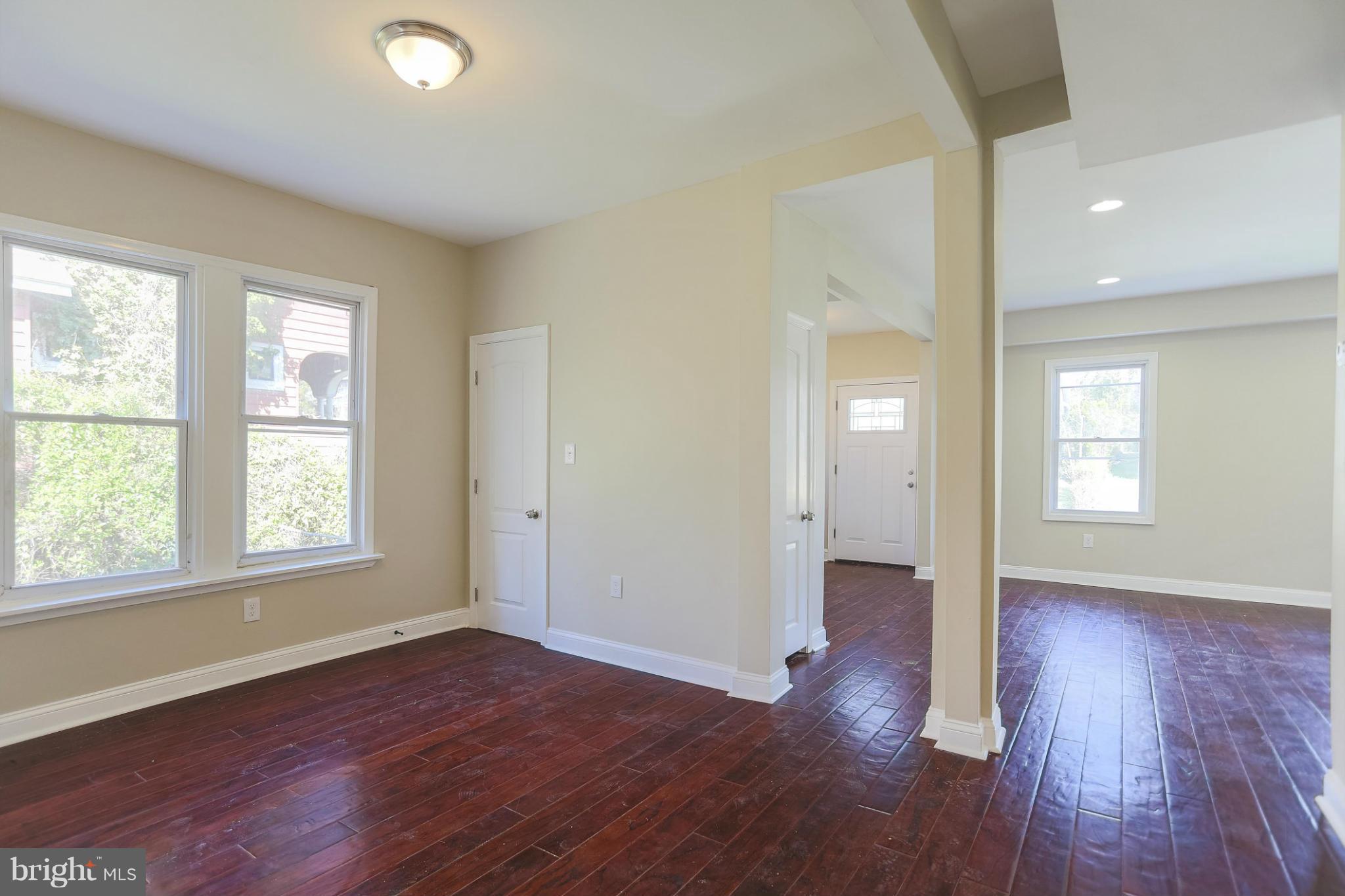 2304 Monticello Road Baltimore, MD 21216 - Photo 1 of 30 an empty room with wooden floor and windows