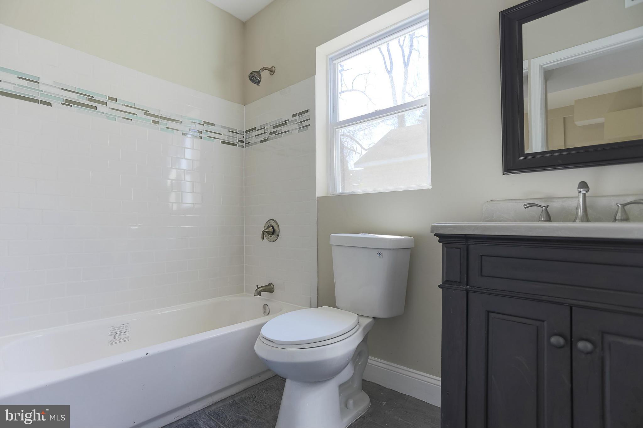 2304 Monticello Road Baltimore, MD 21216 - Photo 16 of 30 a bathroom with a sink toilet and shower