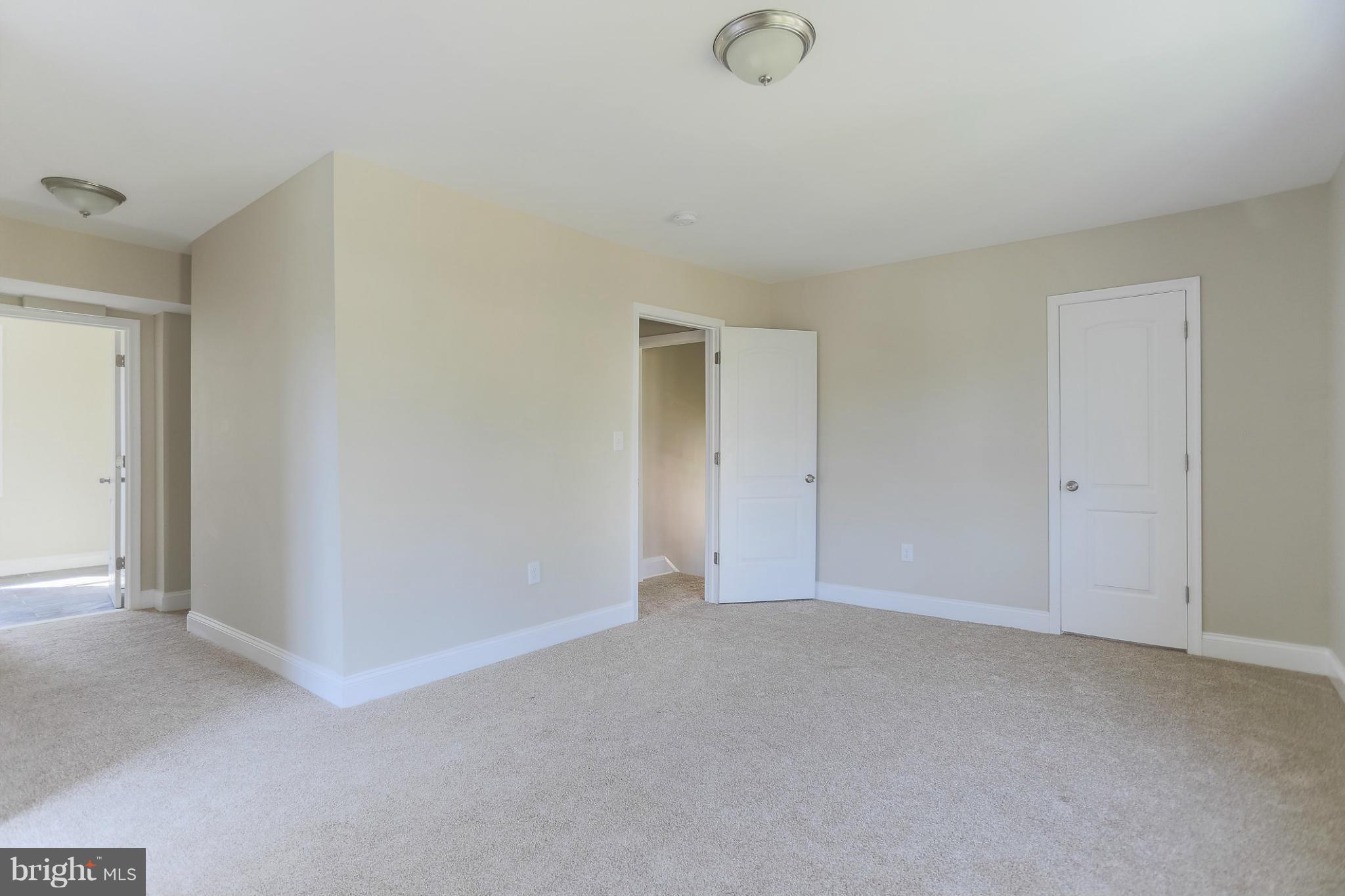 2304 Monticello Road Baltimore, MD 21216 - Photo 18 of 30 a view of an empty room and chandelier fan