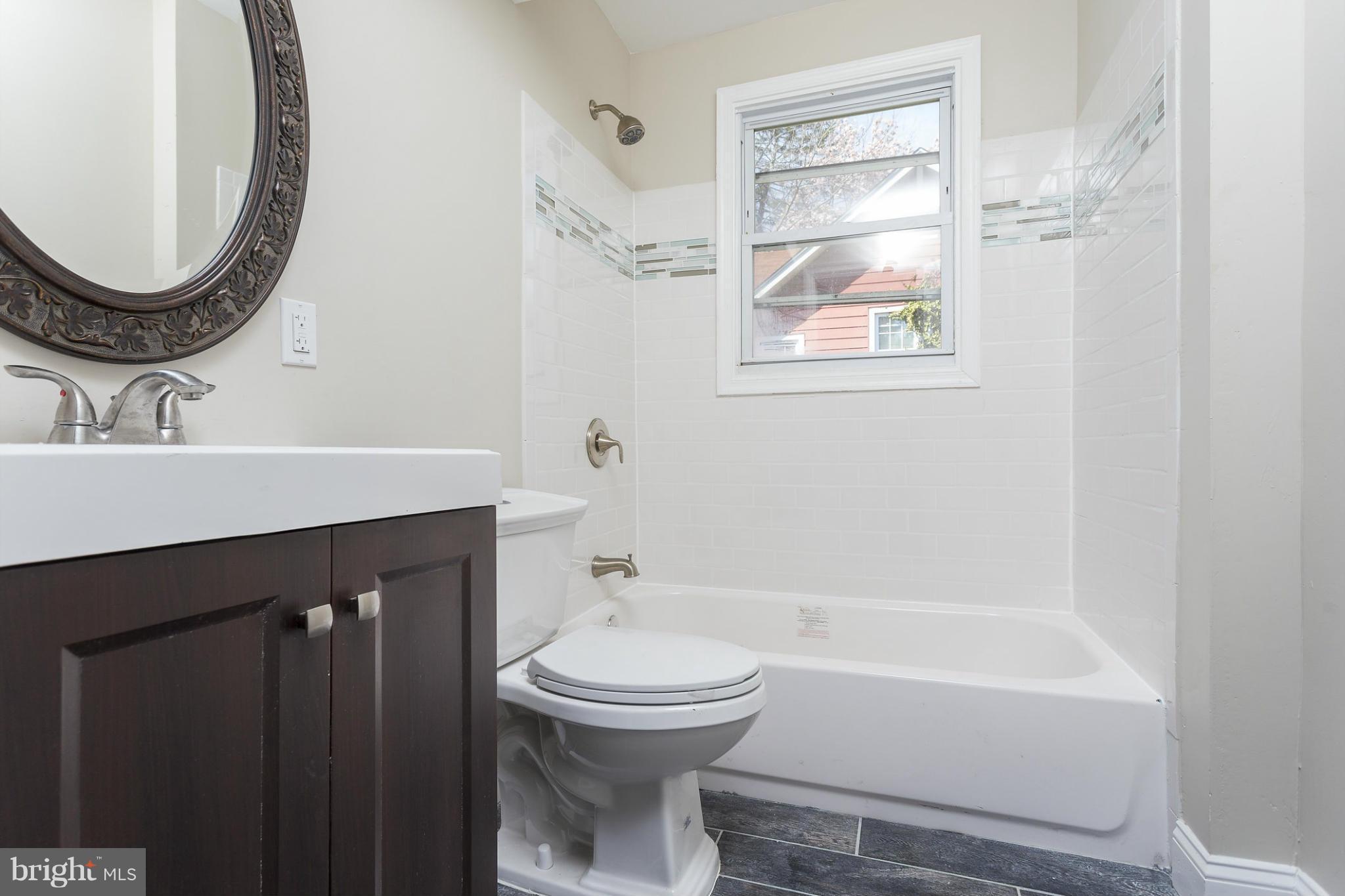 2304 Monticello Road Baltimore, MD 21216 - Photo 19 of 30 a bathroom with a sink a toilet and a mirror