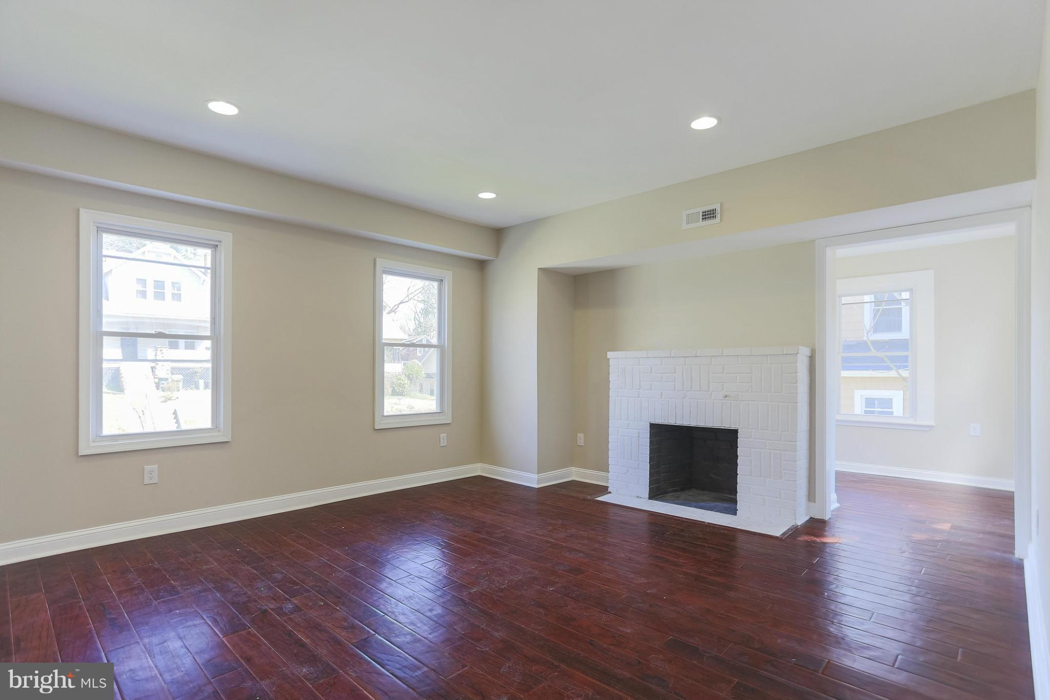 2304 Monticello Road Baltimore, MD 21216 - Photo 7 of 30 a view of an empty room with wooden floor and a window