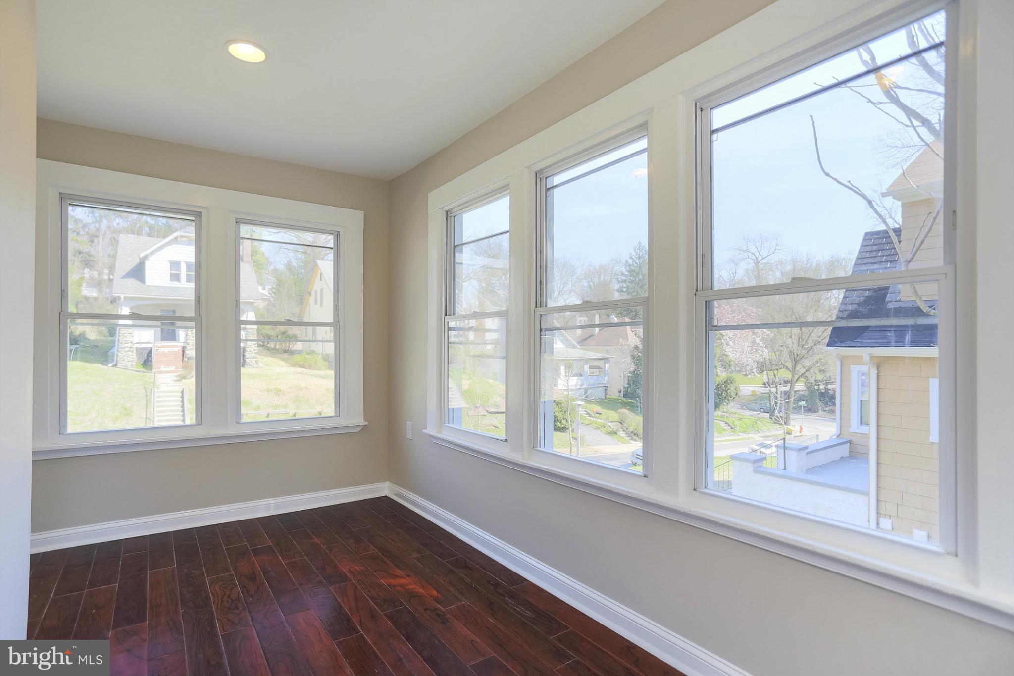 2304 Monticello Road Baltimore, MD 21216 - Photo 8 of 30 an empty room with wooden floor and windows