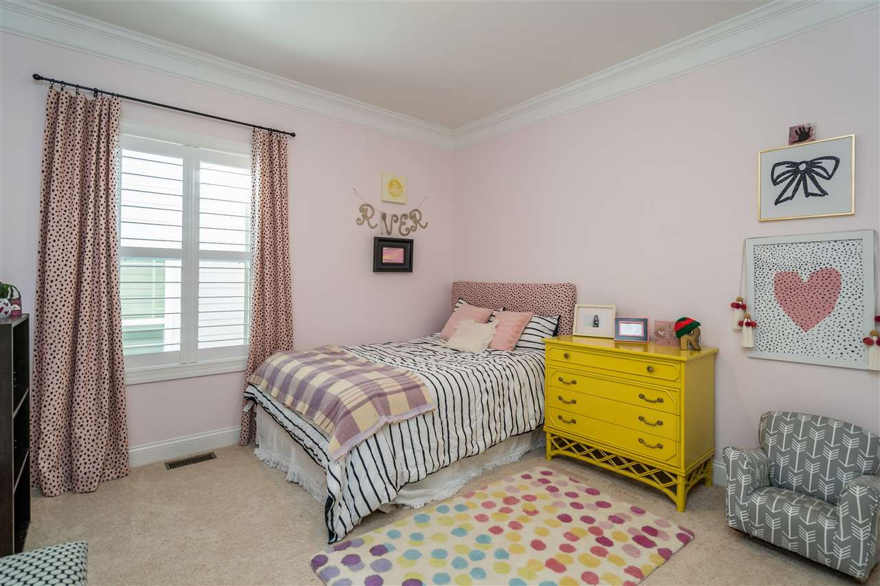 1400 Van Page Boulevard Raleigh, NC 27607 - Photo 29 of 30 Light filled bedroom with shutters and wooden shelving in the closet. Bedroom