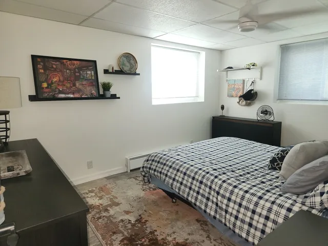 a bedroom with a bed and a window