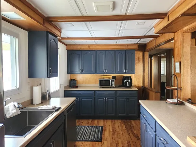 a kitchen with wooden cabinets and sink