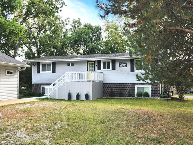 a front view of a house with a garden