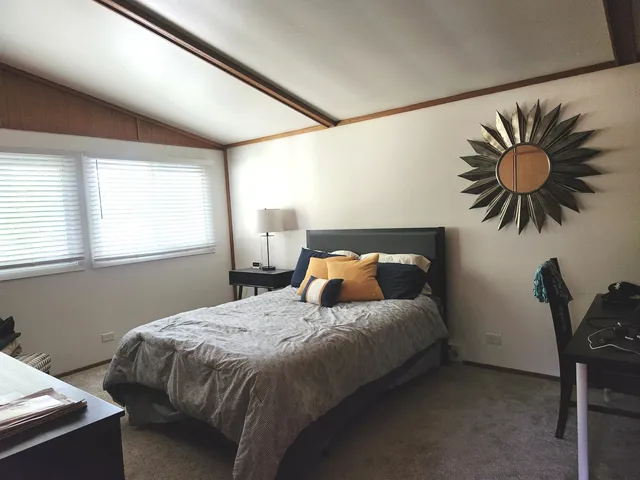 a bedroom with two beds and a window