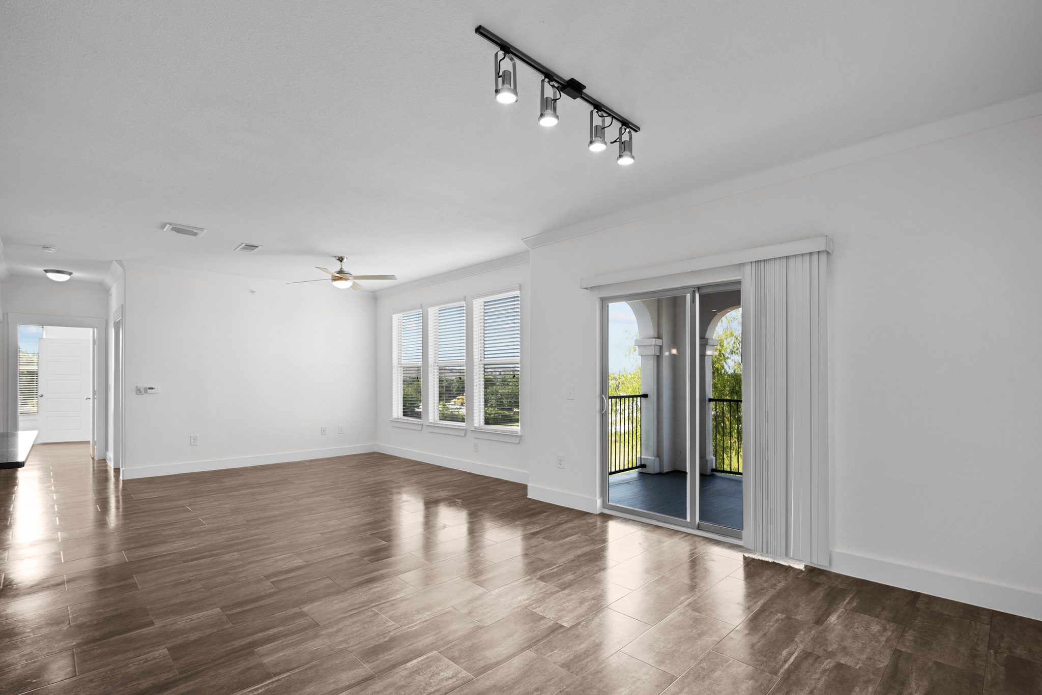 366 Fm 1488 Road, Unit 1042 Conroe, TX 77384 - Photo 2 of 38 a view of an empty room with wooden floor and a window