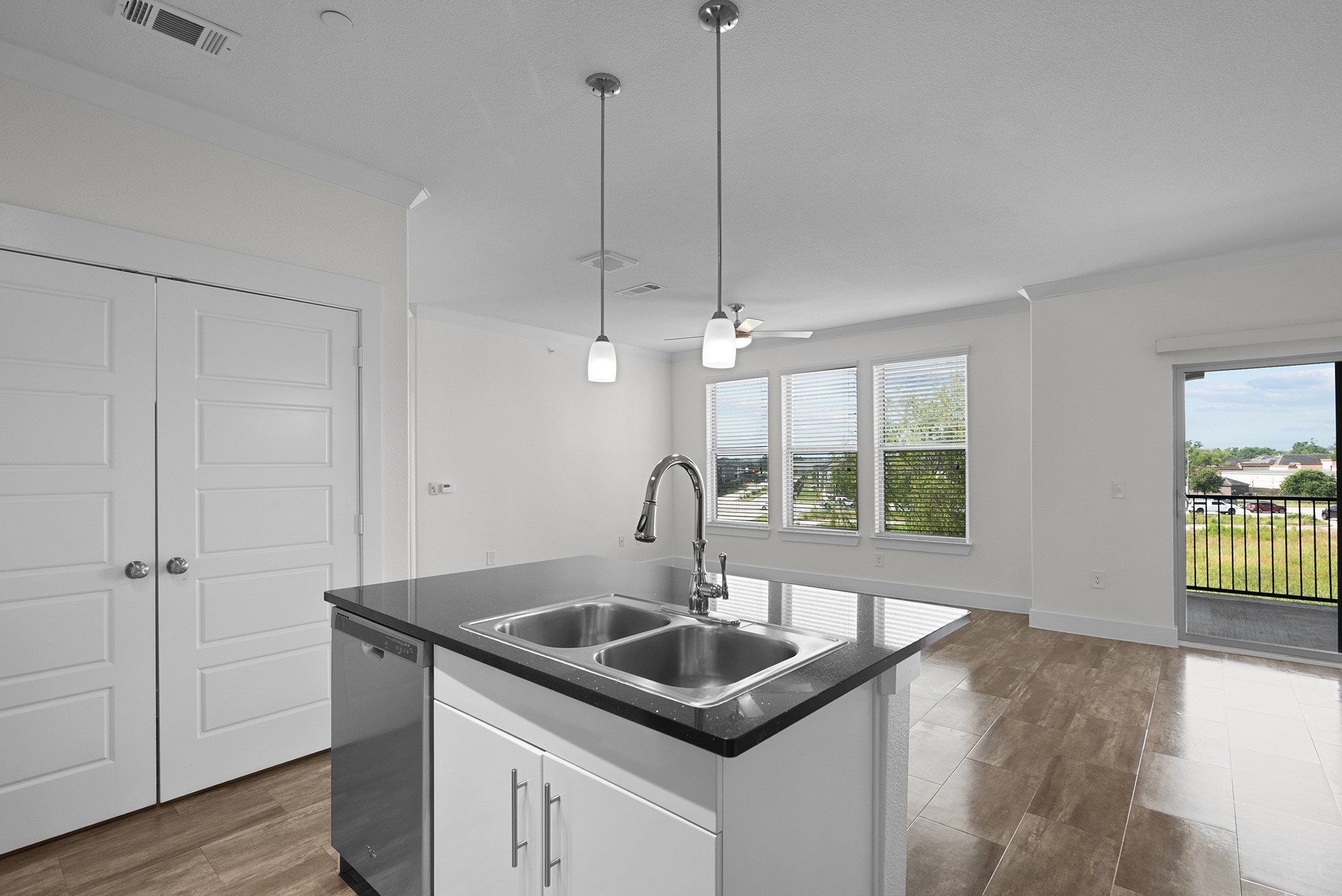 366 Fm 1488 Road, Unit 1042 Conroe, TX 77384 - Photo 6 of 38 a kitchen with a sink a window and wooden floor