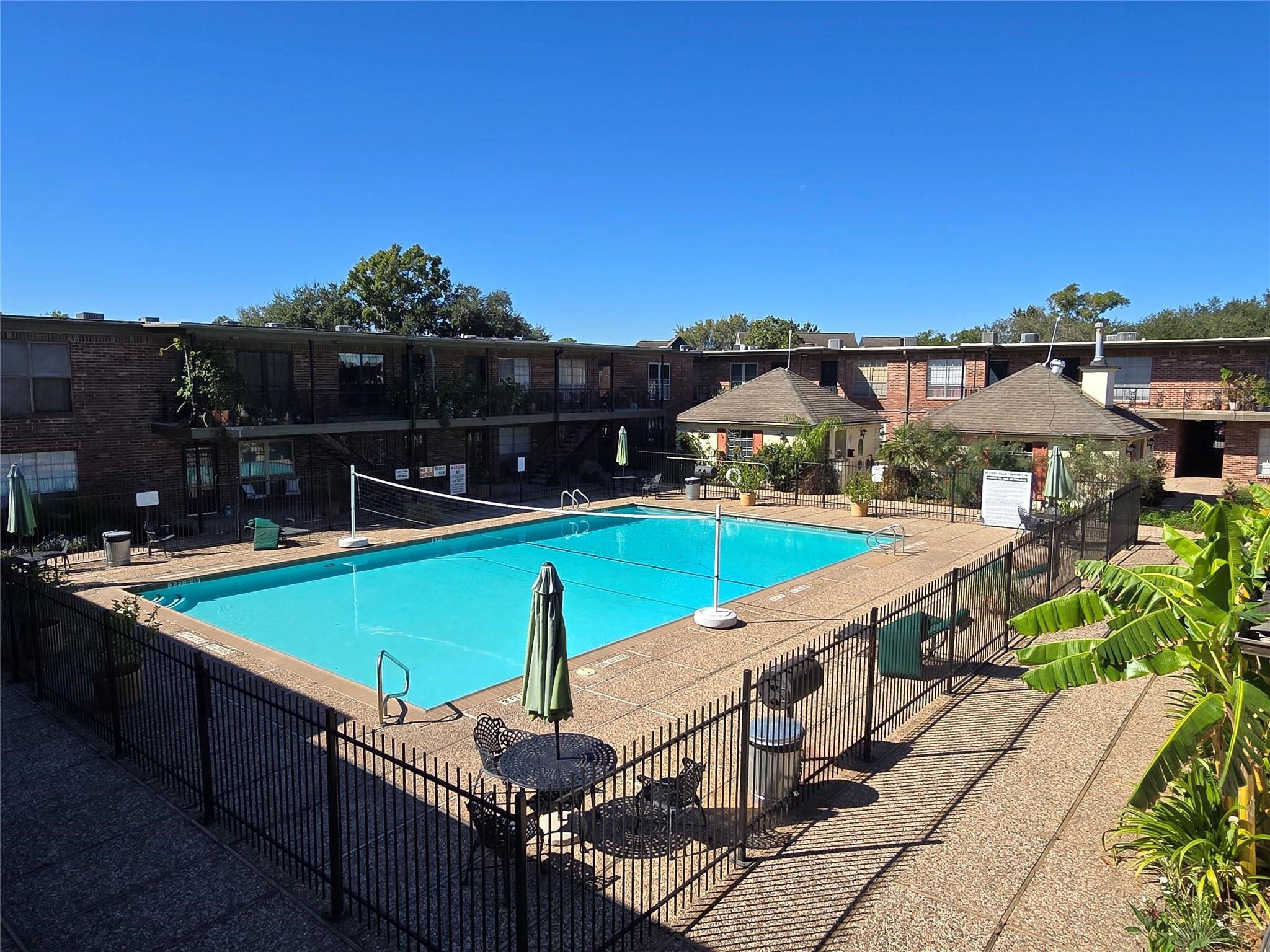 11550 Chimney Rock Road, Unit 312 Houston, TX 77035 - Photo 15 of 18 a view of a backyard with swimming pool and sitting area