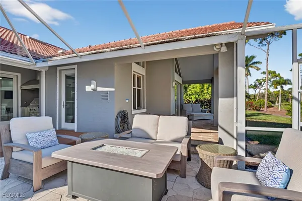 a view of a patio with couches table and chairs with potted plants