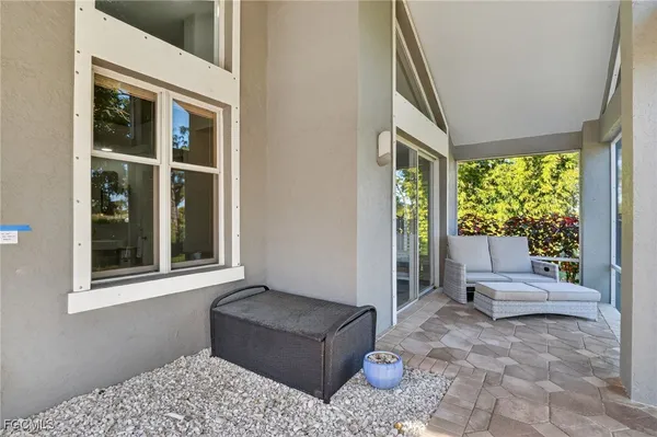 a living room with furniture and large windows