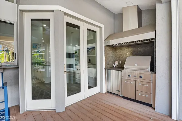 a view of a hallway with wooden floor and closet