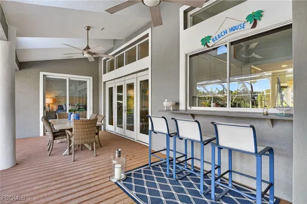 a dining room with wooden floor a chandelier a glass table and chairs
