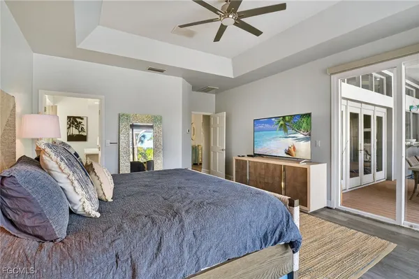 a bedroom with a bed and a chandelier