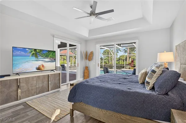 a bedroom with a bed and a large window with outer view
