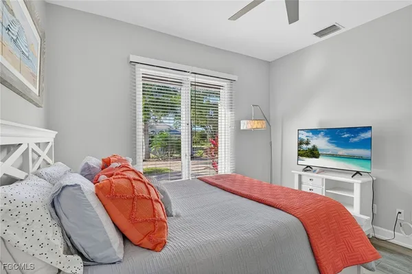 a bed sitting in a bedroom next to a window