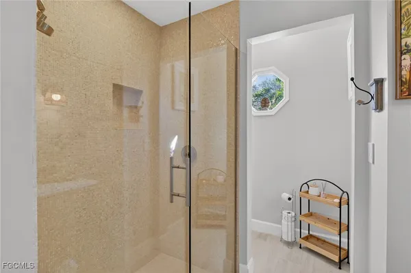 a bathroom with a shower and mirror