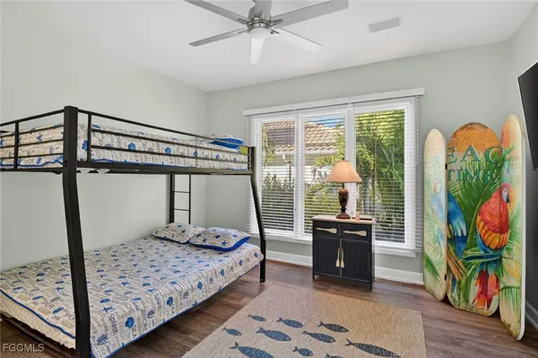 a bedroom with a bed a large window and book self