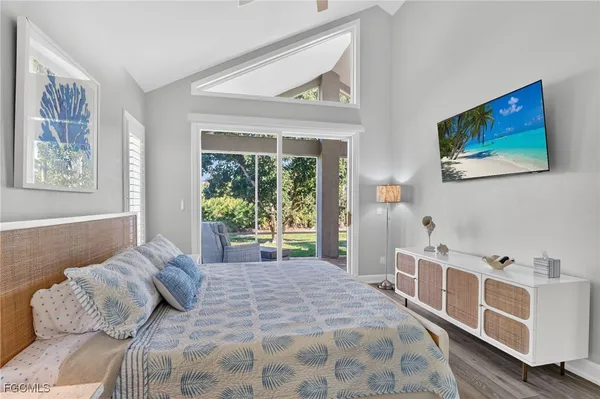 a bedroom with a bed and a large window