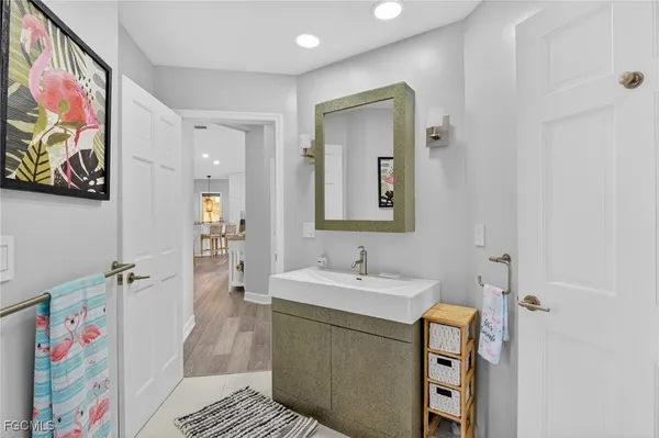 a bathroom with a sink a vanity and a mirror