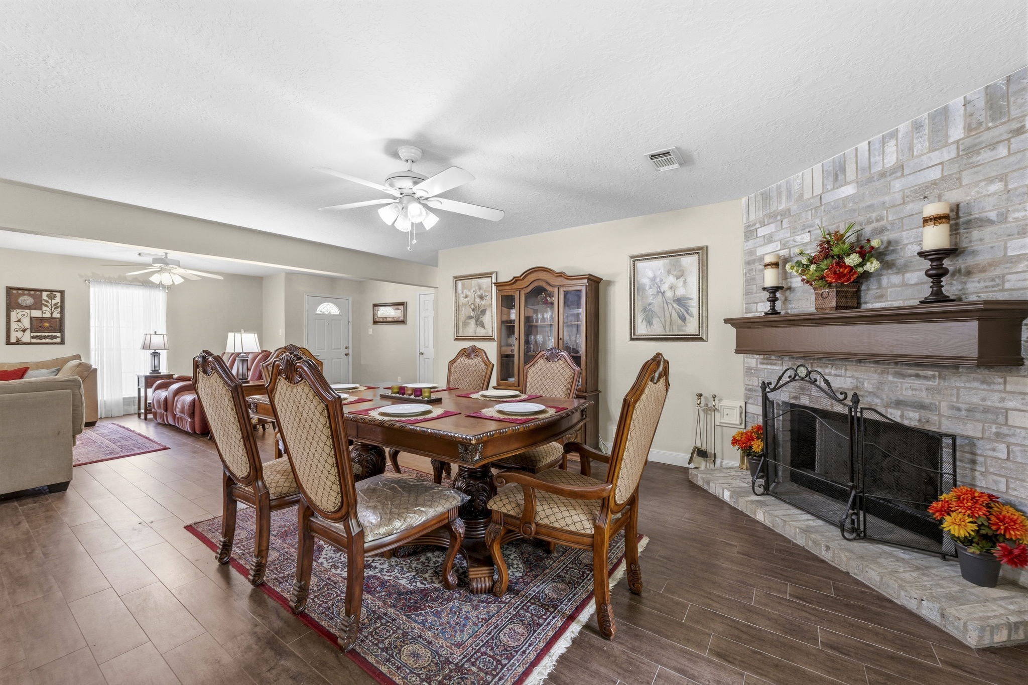 21809 Tophill Drive Spring, TX 77388 - Photo 11 of 50 a dining room with furniture a fireplace and wooden floor