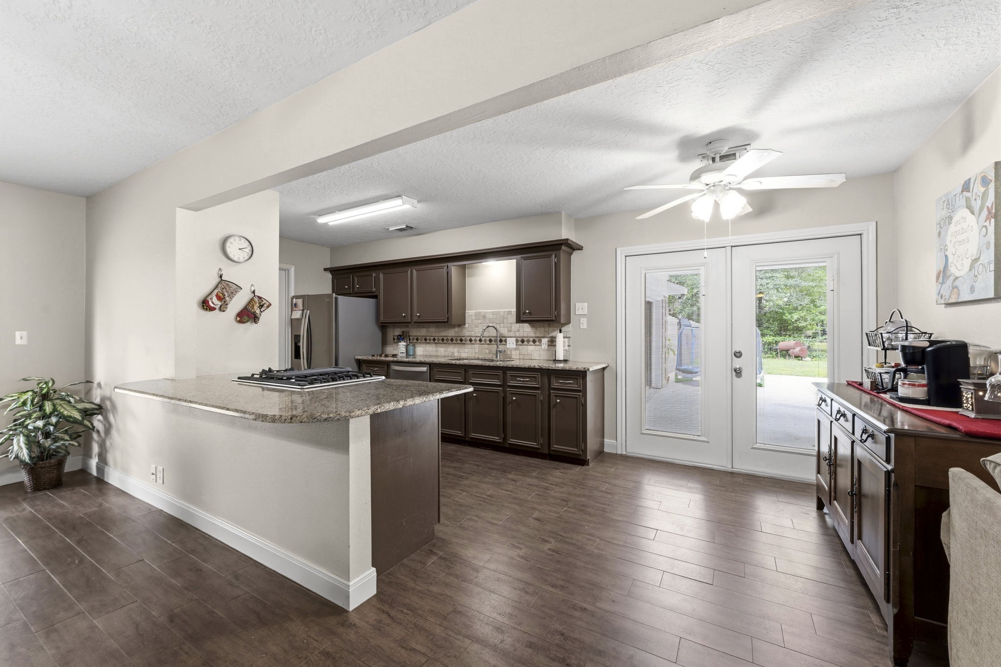 21809 Tophill Drive Spring, TX 77388 - Photo 12 of 50 a kitchen with stainless steel appliances kitchen island a sink stove and refrigerator