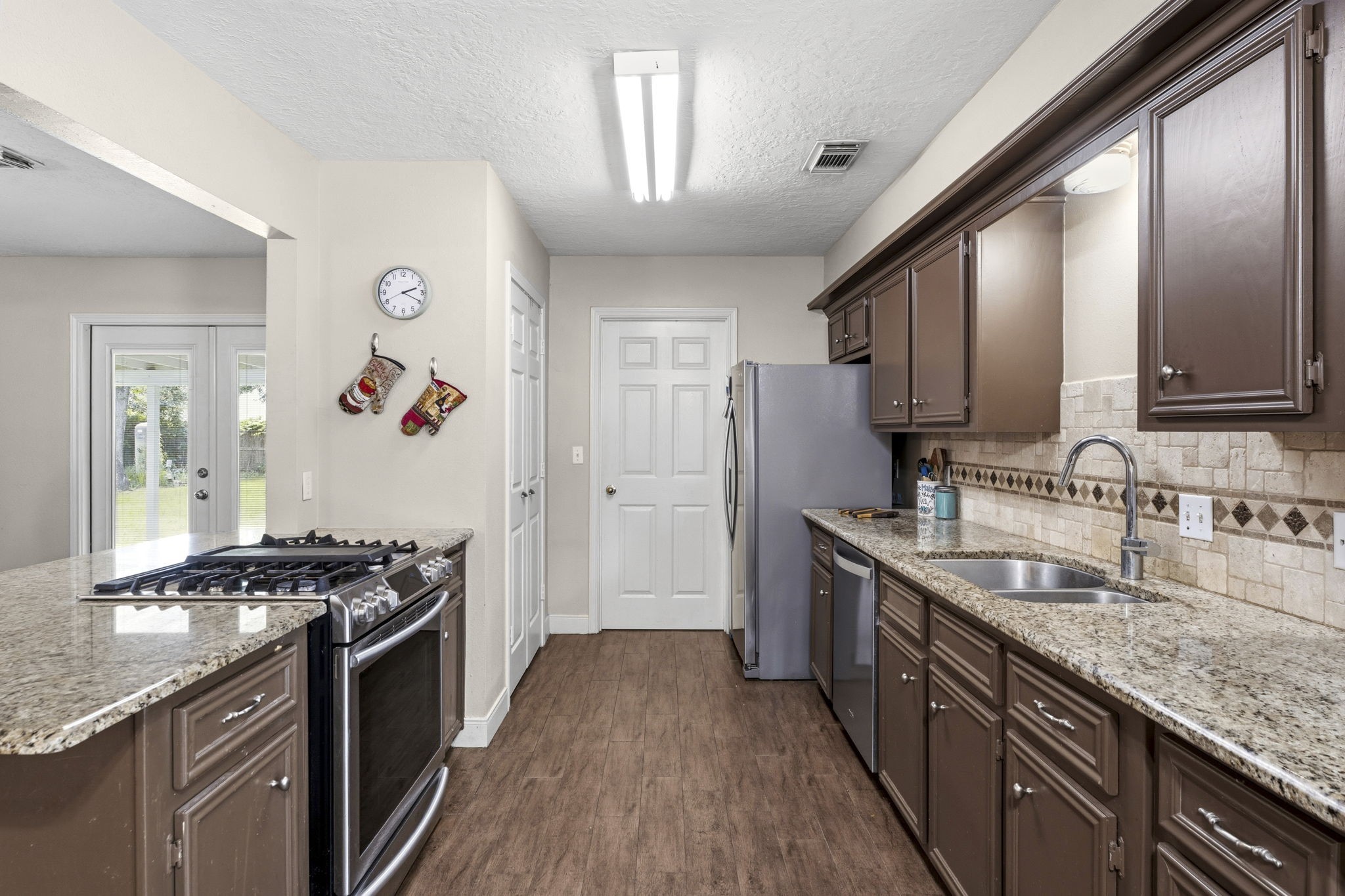 21809 Tophill Drive Spring, TX 77388 - Photo 16 of 50 a kitchen with stainless steel appliances granite countertop a stove and a sink