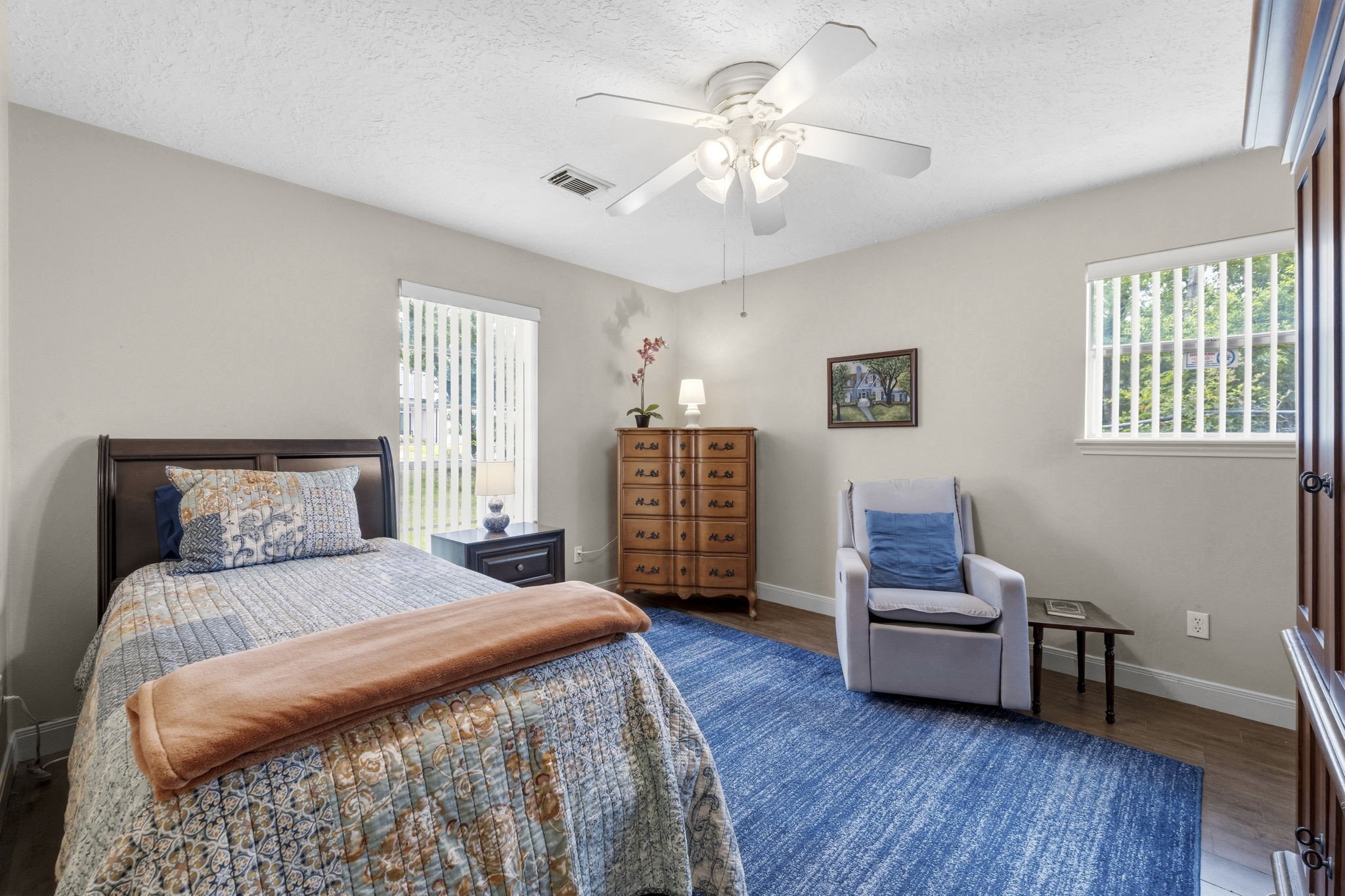 21809 Tophill Drive Spring, TX 77388 - Photo 24 of 50 a bedroom with a bed a dresser and a chandelier