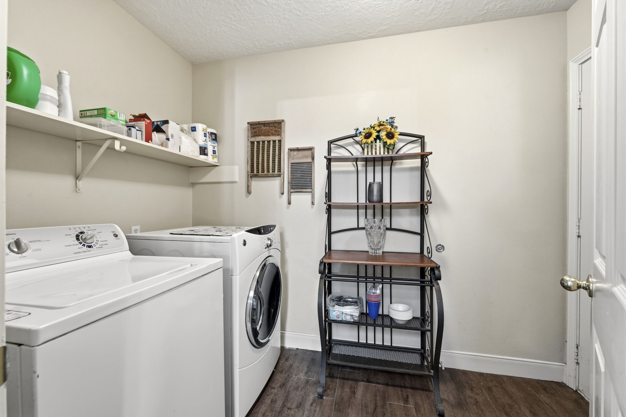 21809 Tophill Drive Spring, TX 77388 - Photo 28 of 50 a view of washer and dryer with kitchen in the background