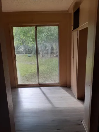 a view of room with window and wooden floor