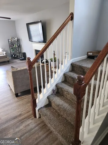 a view of staircase with wooden floor and windows