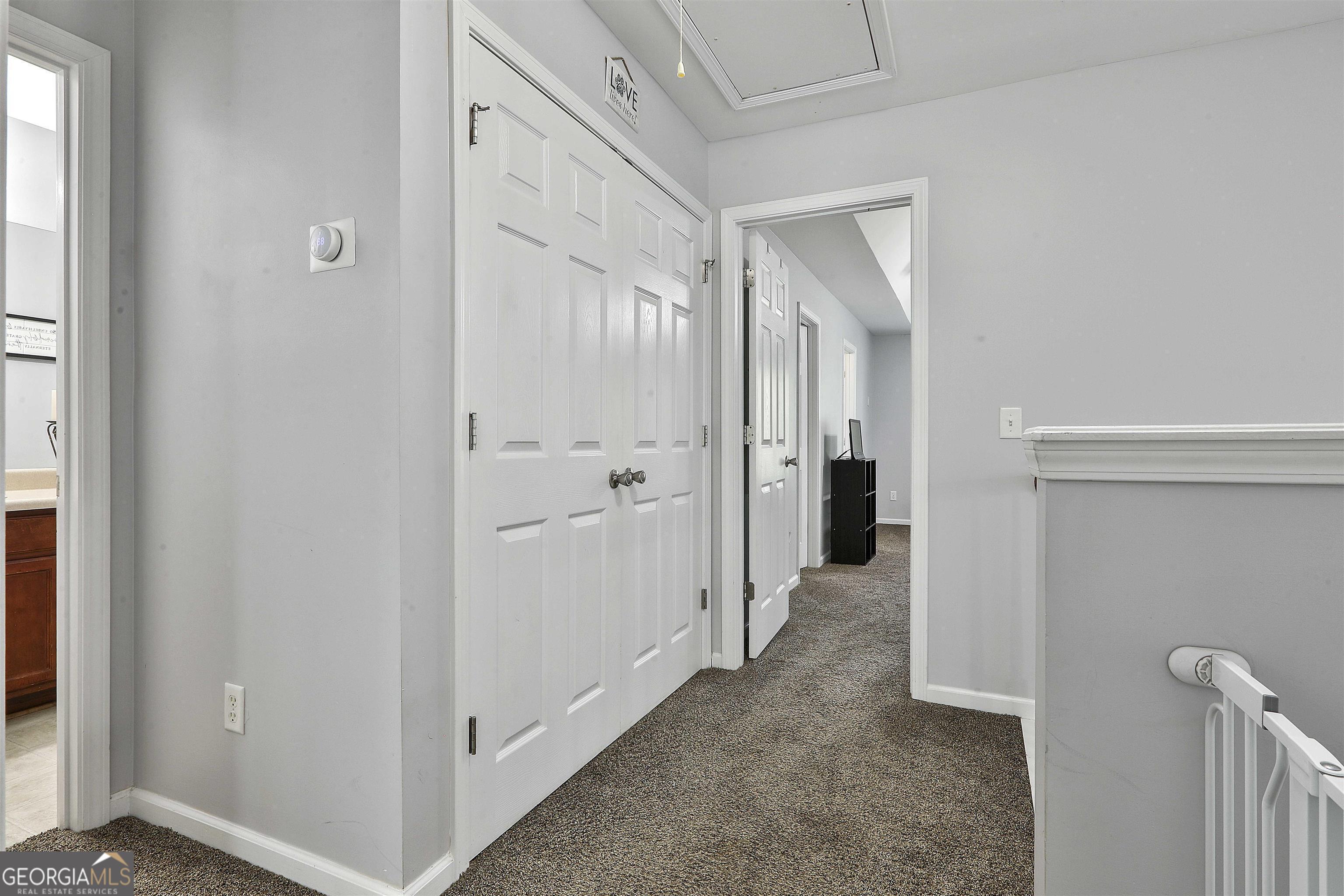 49 Preserve Drive Newnan, GA 30263 - Photo 7 of 17 a view of a hallway with wooden shelves