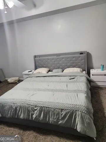 a bedroom with a bed and a couch