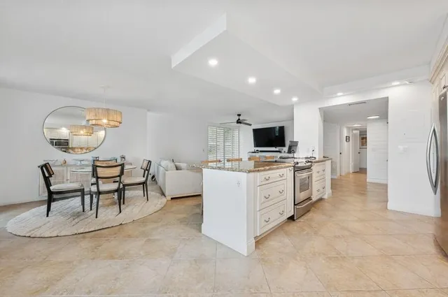 a view of a dining room with furniture and a kitchen