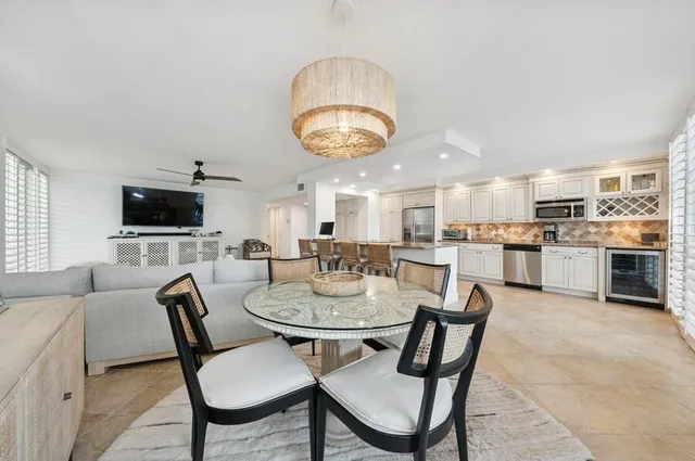 a dining room with wooden floor a glass table and chairs
