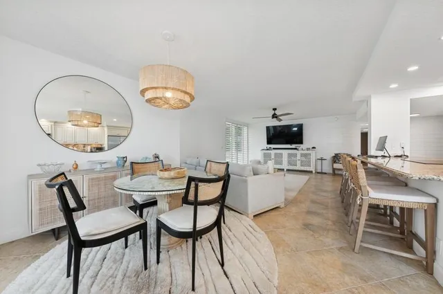 a dining room with furniture and a mirror