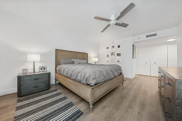a bathroom with a granite countertop sink a toilet and a mirror