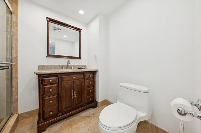 a bathroom with a sink vanity and a mirror
