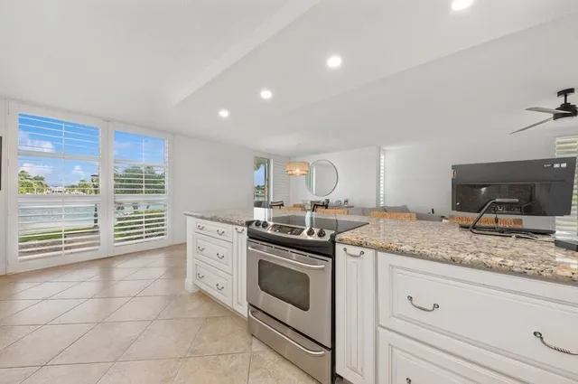 a kitchen with a stove sink and cabinets