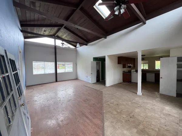 a view of an empty room with closet and windows