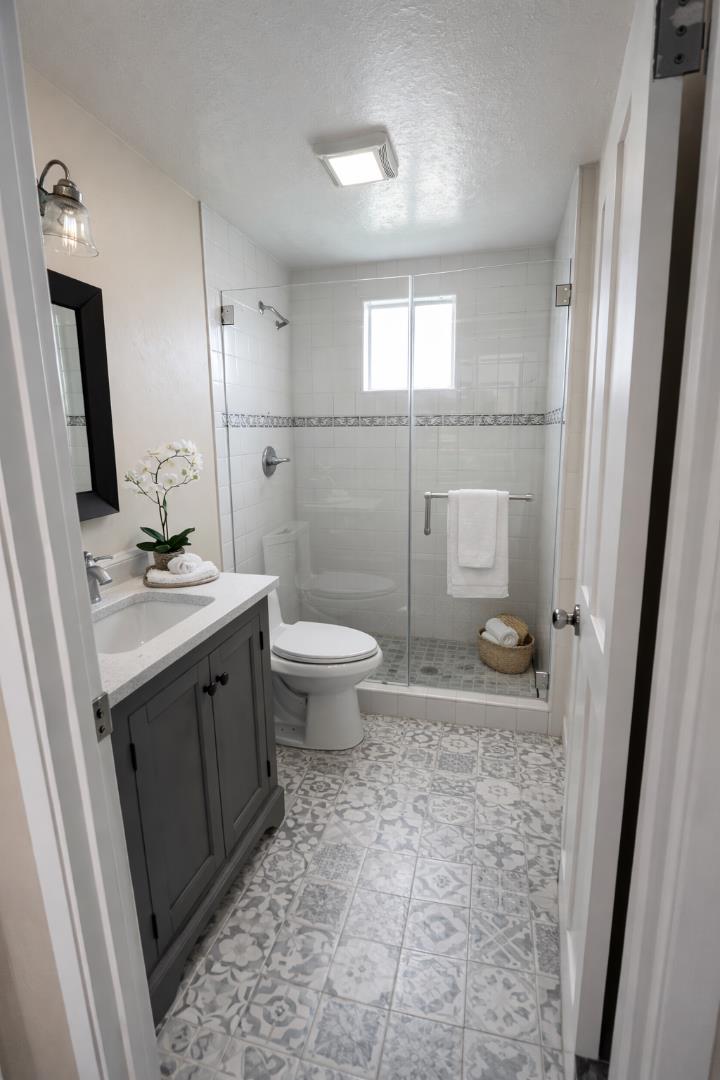 6125 Abbey Road Aptos, CA 95003 - Photo 5 of 7 a bathroom with a sink toilet a mirror and vanity