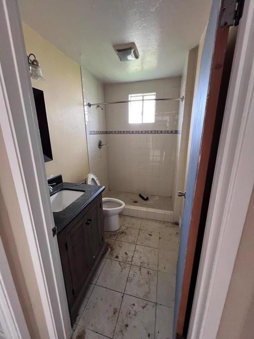6125 Abbey Road Aptos, CA 95003 - Photo 6 of 7 a bathroom with a granite countertop sink toilet and shower