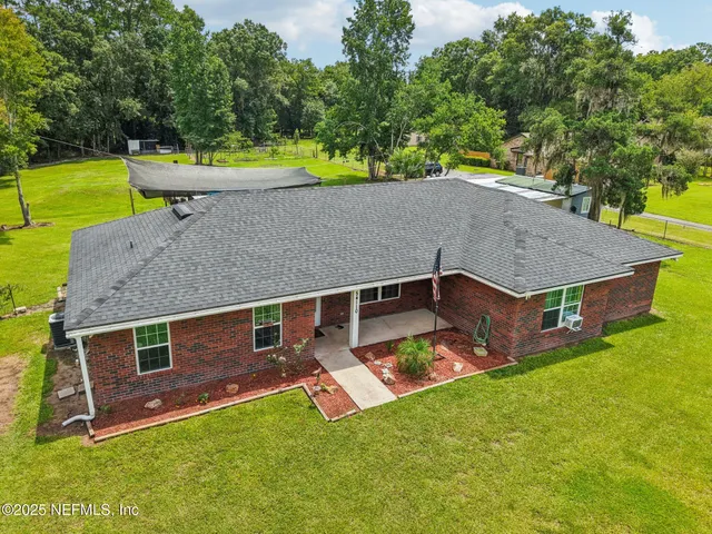 an aerial view of a house having swimming pool
