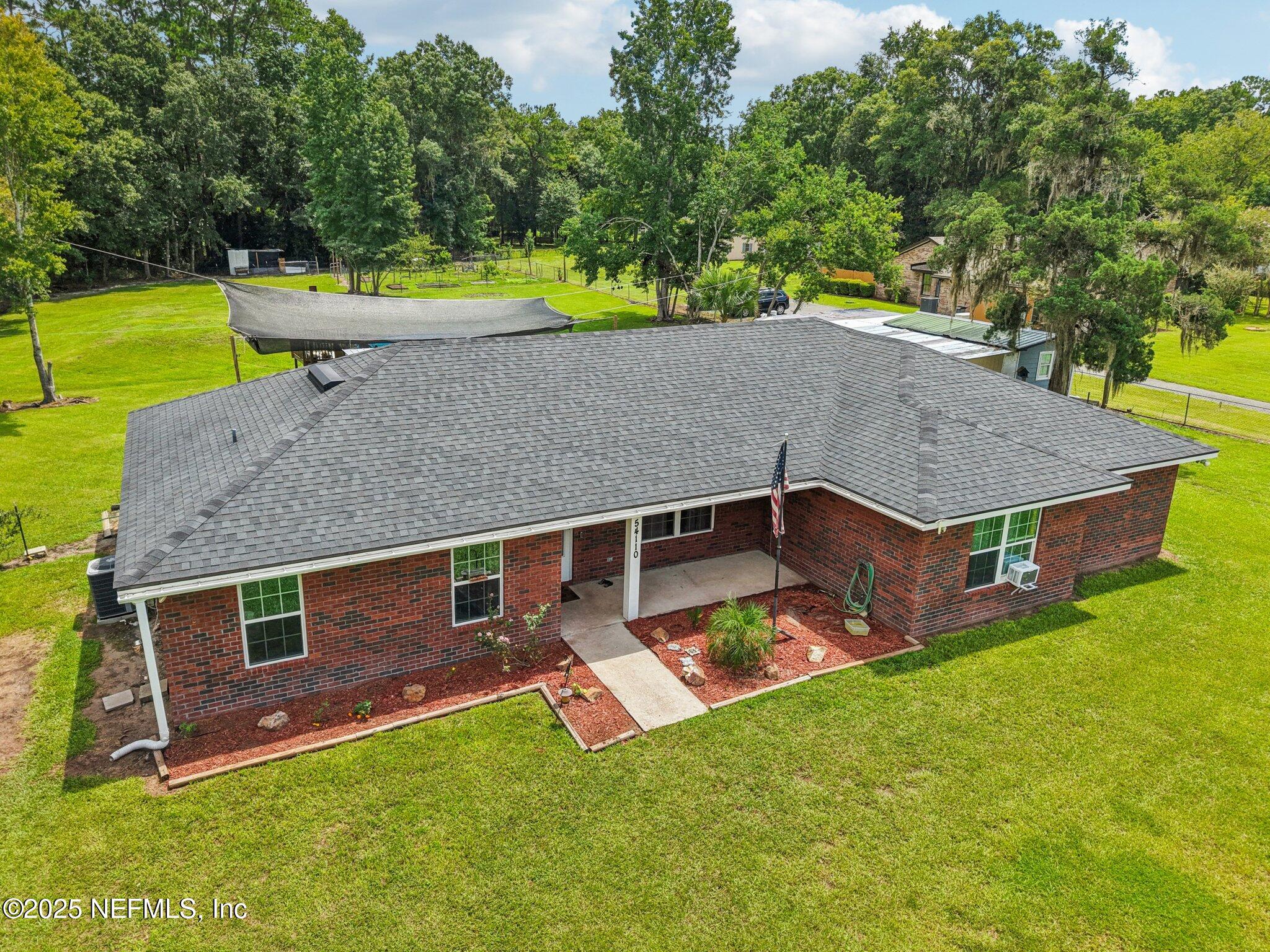an aerial view of a house having swimming pool