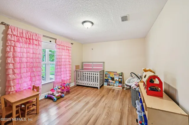 a bedroom with furniture and a wooden floor