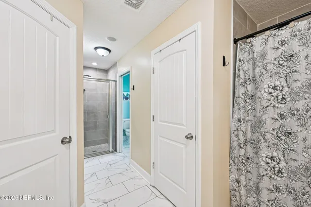 a bathroom with a shower and a sink
