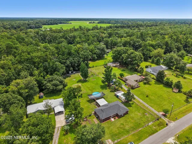 an aerial view of residential houses with outdoor space and street view