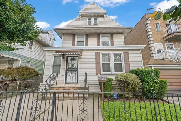 a view of a white house with large windows